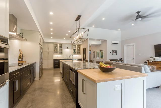 A kitchen with a large island and a large couch.